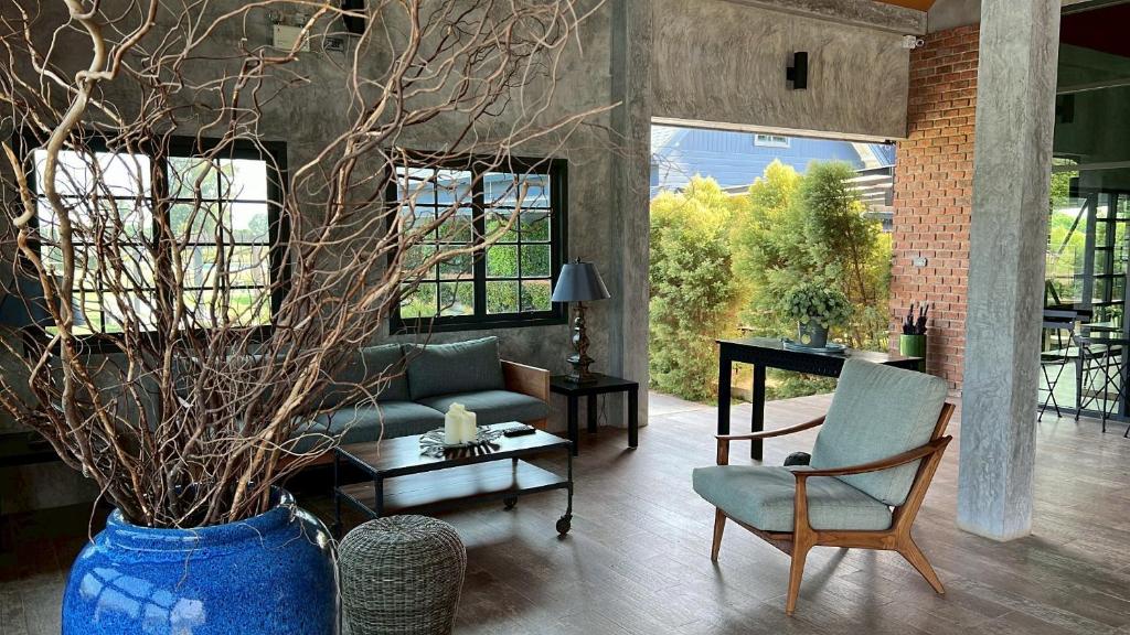 a living room with a couch and a chair at The Barn Hua Hin in Khao Tao
