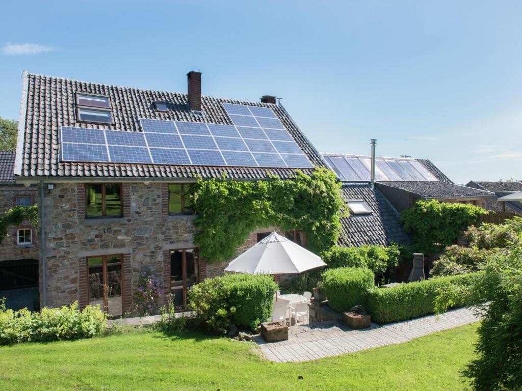 a house with solar panels on the roof at Desnié Farmhouse with Pool in Desnié