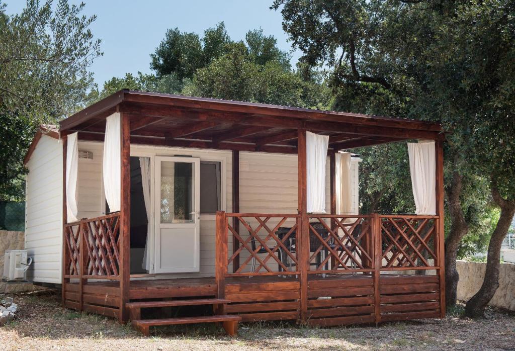 a small cabin with a porch and a door at Apartment Malibu in Zaboric