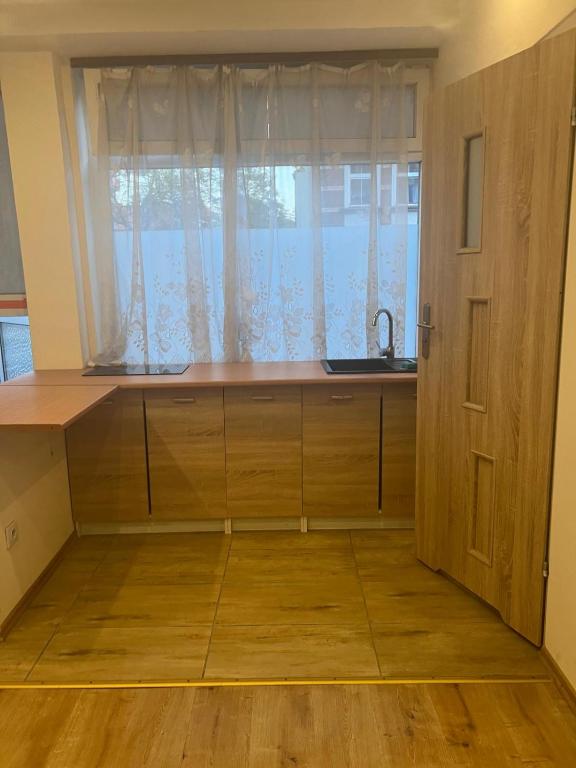 a kitchen with a sink and a window at Grottgera Inn Bytom in Bytom