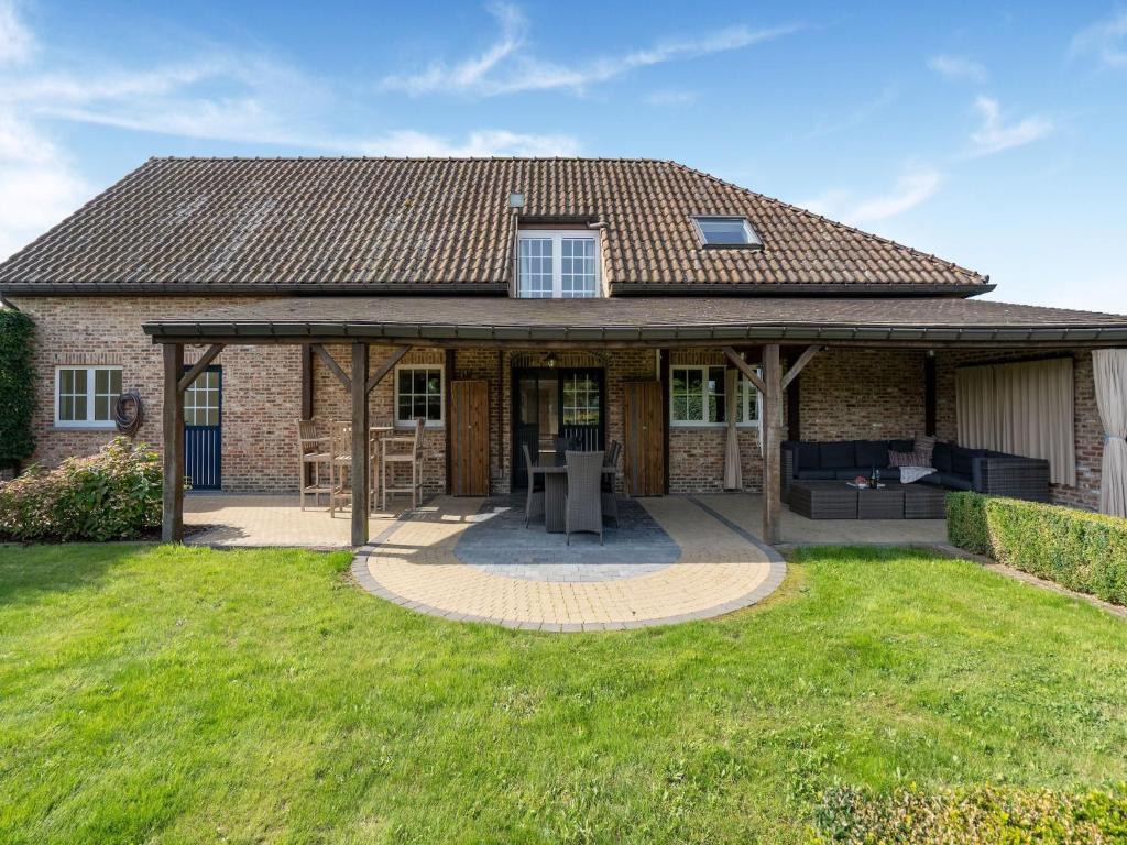 a brick house with a pavilion in a yard at Alken Farm Stay with Terrace in Alken