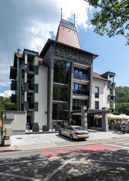 a building with a car parked in front of it at Salt Lake Hotel in Sovata