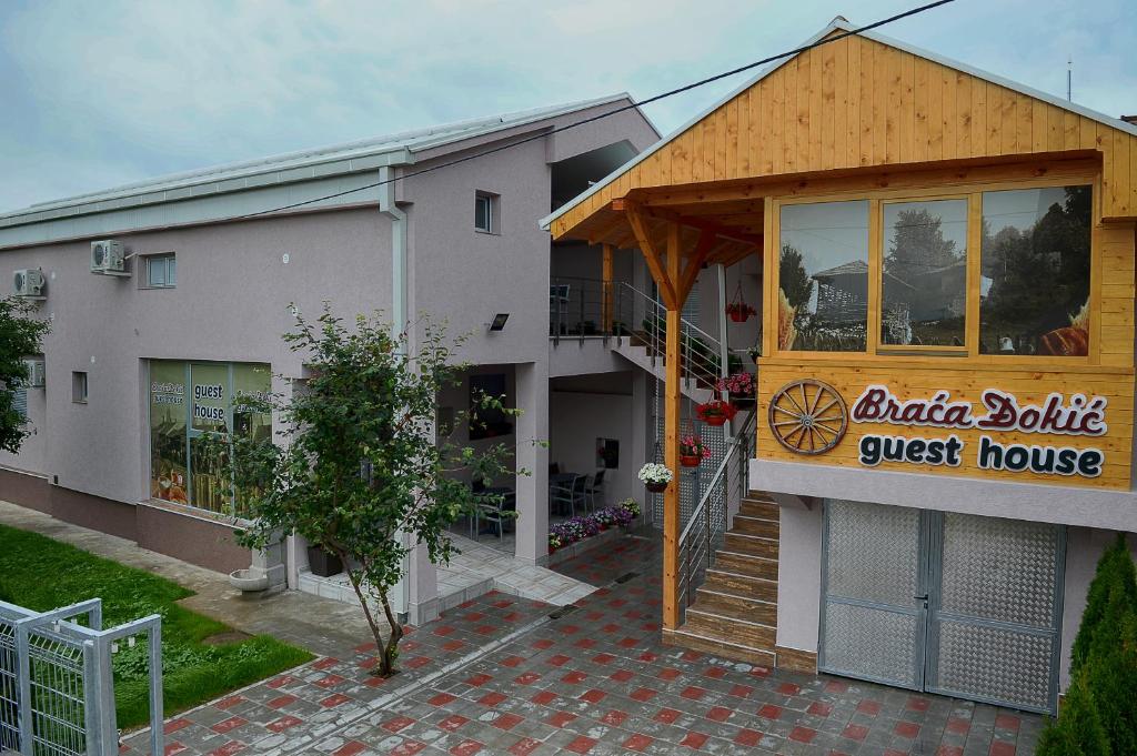 a building with a guest house with a sign on it at Guesthouse Đokić in Leskovac