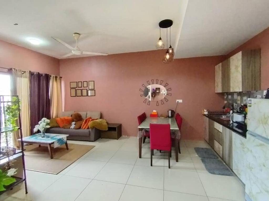 a kitchen and living room with a table and a couch at Pool & Sea View Casa Azalea at Swiss Garden Resort Residence - 2 bedroom apartment in Kuantan