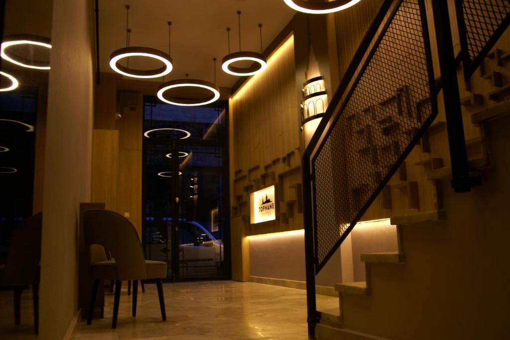 a hallway with chairs and lights in a store at Tophane Suites in Istanbul