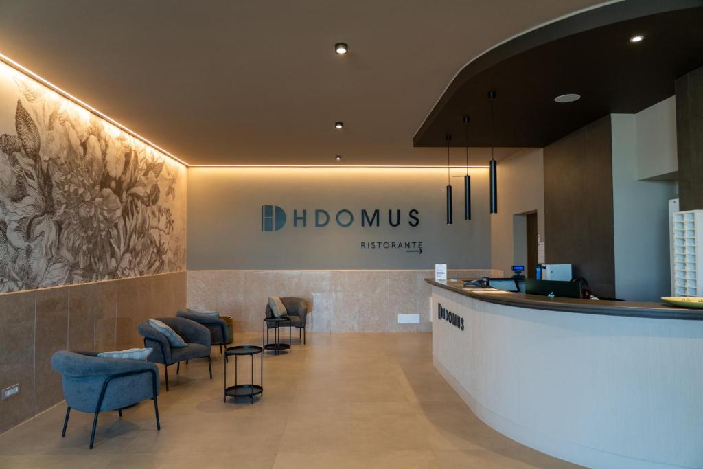a lobby with chairs and a bar in a hospital at Hotel HDomus in Nogarole Rocca
