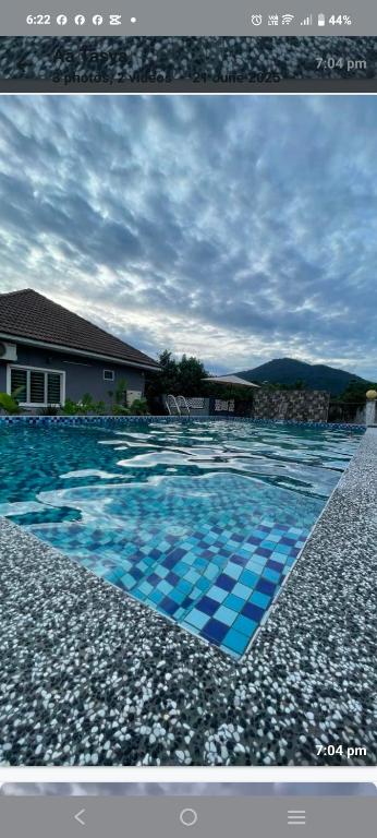 a picture of a swimming pool with blue tiles at Homestay Azkha in Langkawi Islands