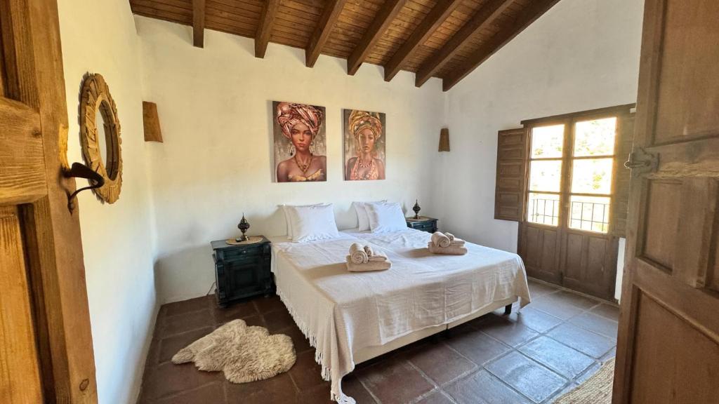 a bedroom with a white bed in a room at Cortijo J&S Juan Salvador in Málaga