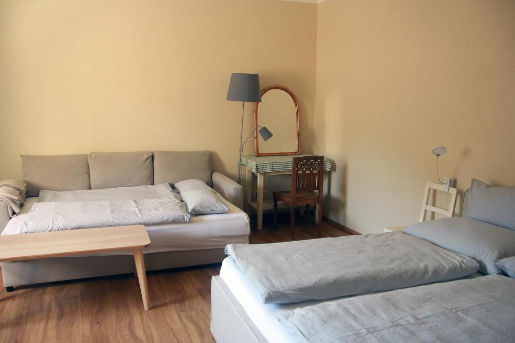 a living room with a couch and a table at Wohnen im Meierhof in Hohenwarth
