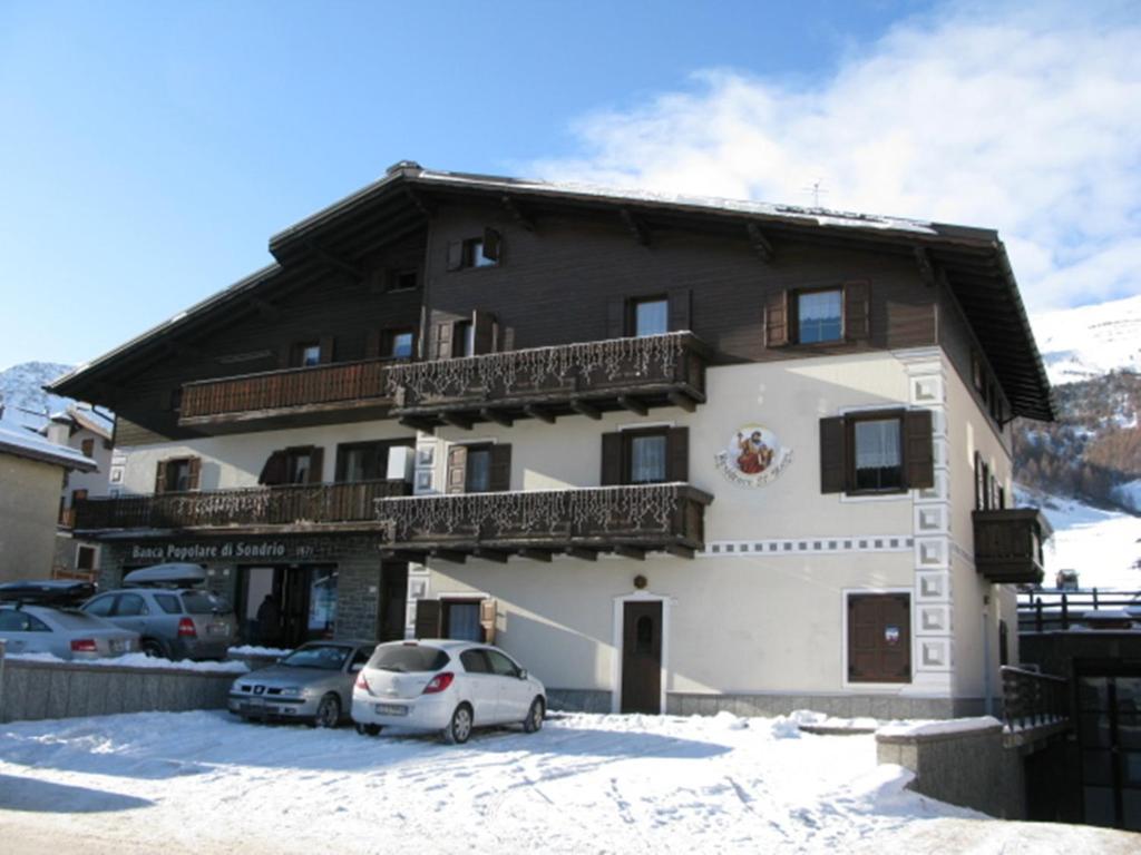 a large building with cars parked in front of it at Residence San Marco by Alpenwhite in Livigno