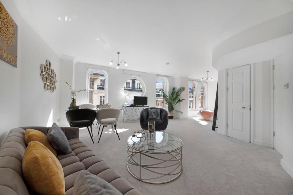 a living room with a couch and a table at 3 Bedroom Penthouse with Roof Terrace in Covent Garden in London