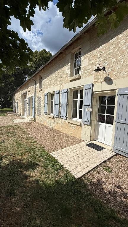 a brick building with blue doors and windows at La Grange de la Boutelaye in Lésigny