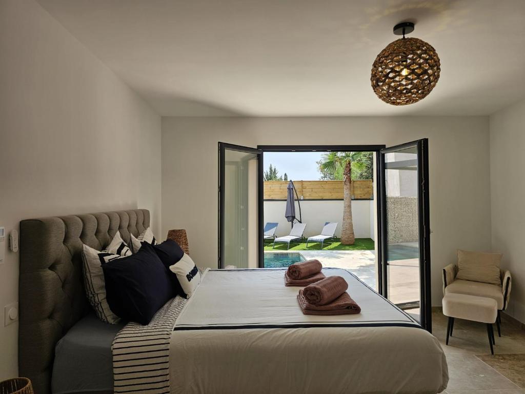 Katil atau katil-katil dalam bilik di Maison Palma - Séjour d'exception avec piscine privée