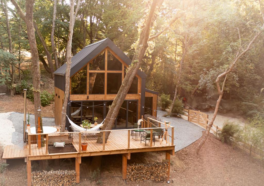 a tree house in the middle of a forest at Ecolodge de la Palombiere in Saint-Clar