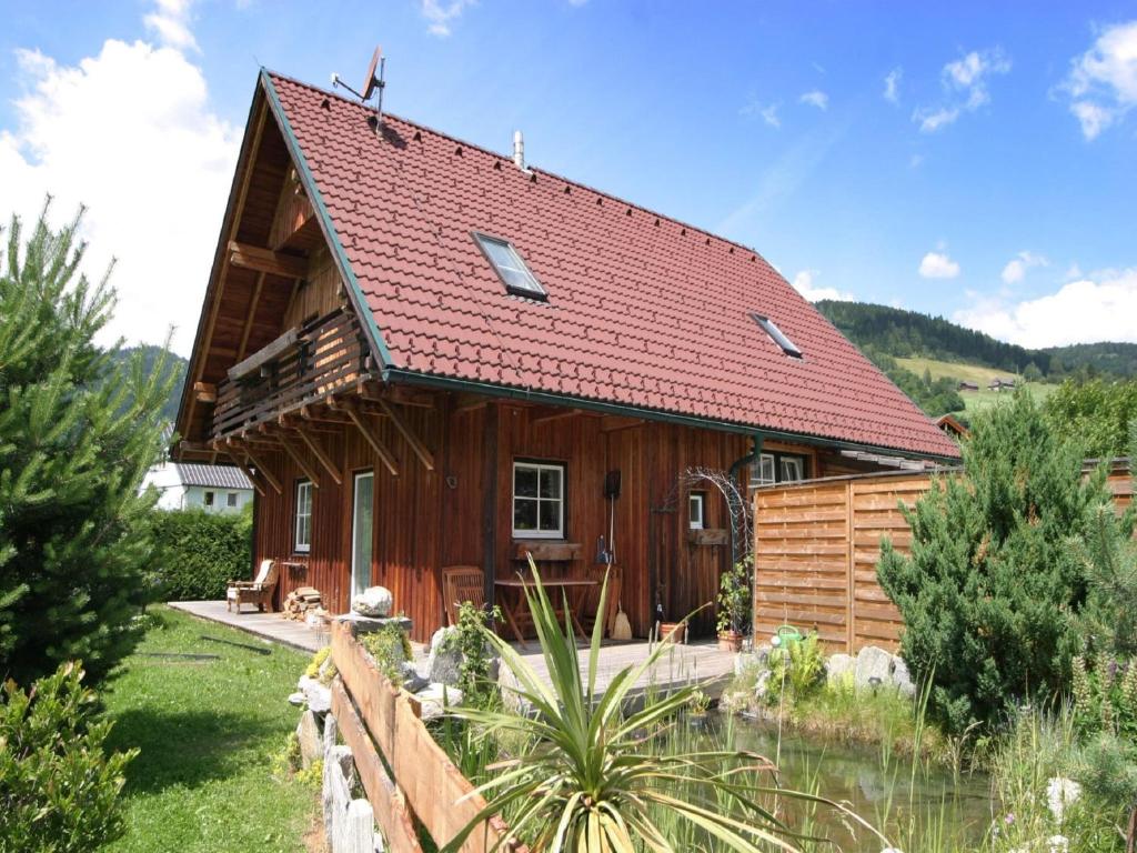 a wooden house with a red roof at Chalet in Einach nahe Skipisten in Einach