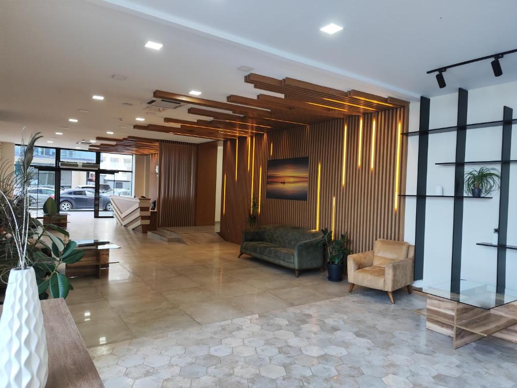 a lobby with a couch and chairs in a building at Aqua Batumi 84 in Batumi