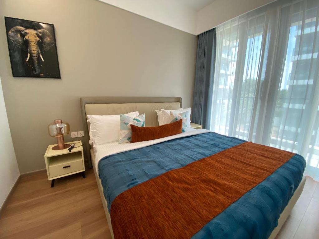 a bedroom with a large bed and a window at The Garden Nook in Dar es Salaam