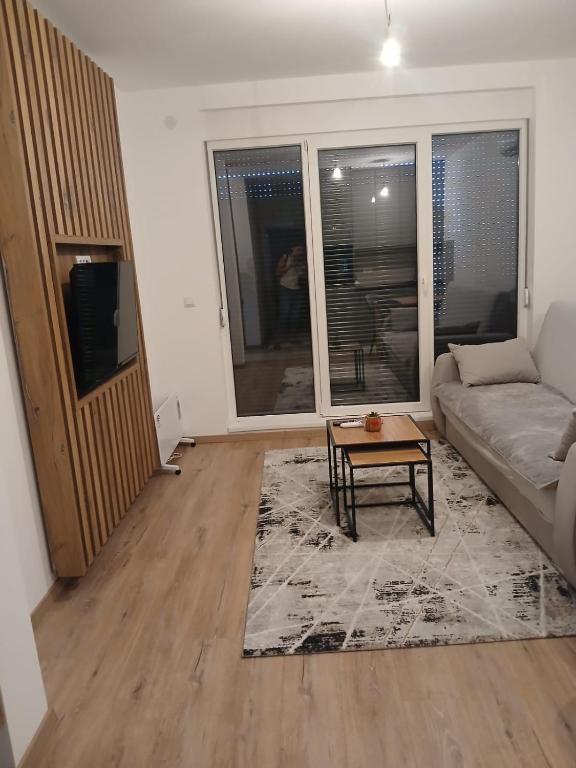 a living room with a couch and a table at Aprtman SALE in Vrnjačka Banja