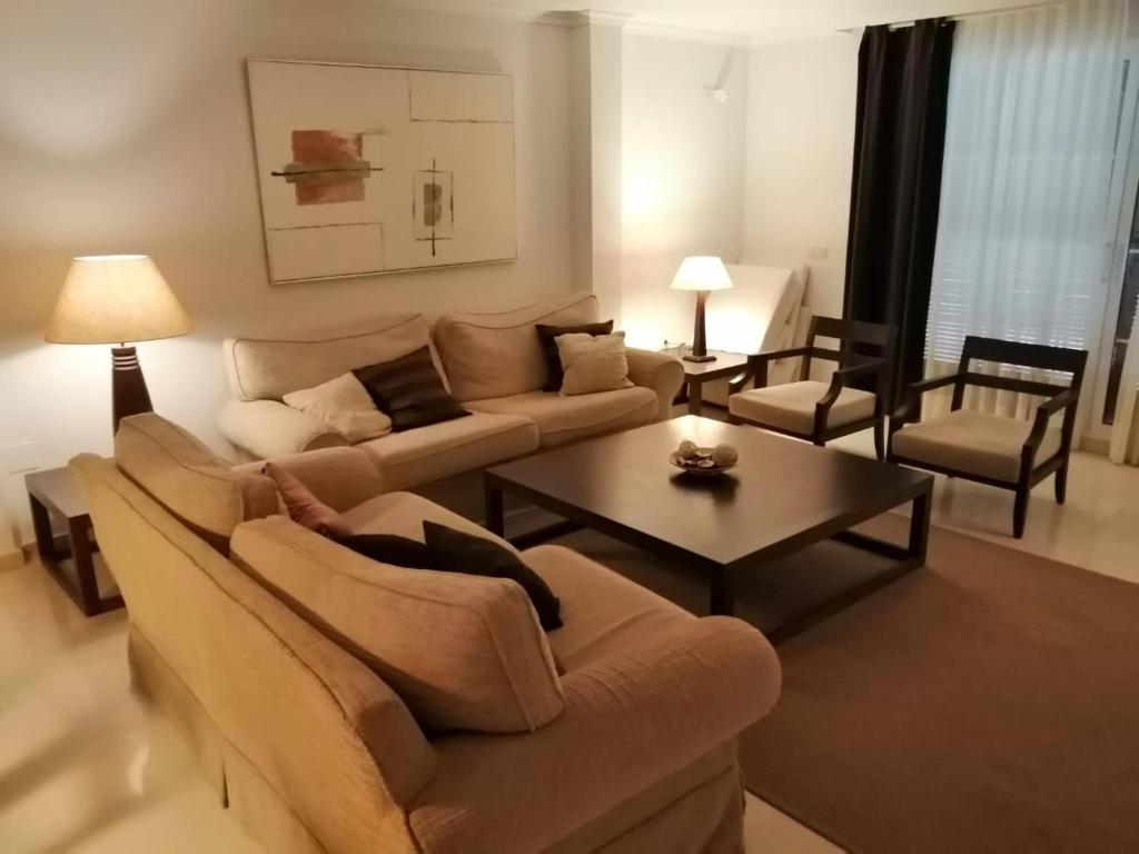 a living room with a couch and a coffee table at Charming 3 Bedroom Apartment in Puerto Sotogrande in Torreguadiaro