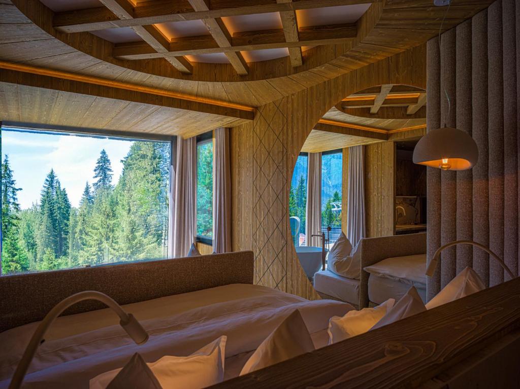 a room with two beds and a large window at Luxury Chalet Strachan - Jacuzzi and Sauna in Ždiar