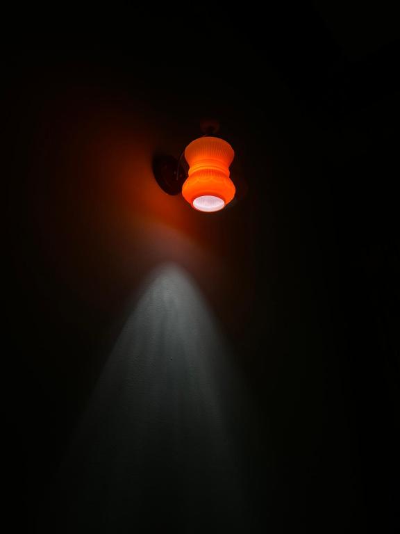 an orange light in the dark with a spotlight at Lý Sơn I Xuân Mai Homestay in Quang Ngai