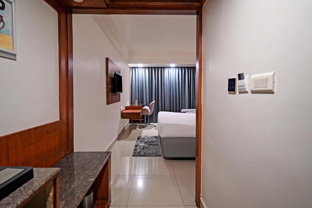 a hotel room with a bed and a desk at Palette Madhapur in Hyderabad
