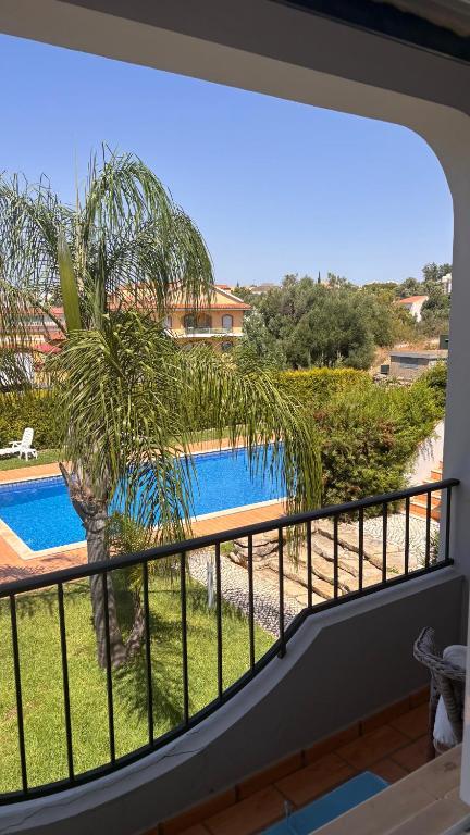 a balcony with a view of a swimming pool at Golden Triangle Retreat Near Quinta do Lago in Almancil