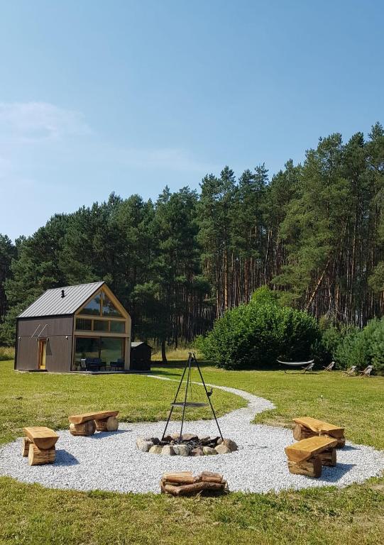 a fire pit in the middle of a field at Dolina nad Drawa in Przeborowo