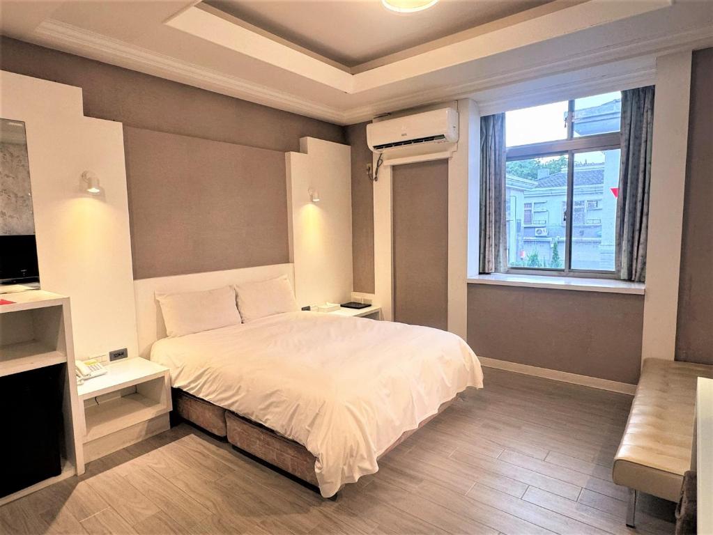 Ένα ή περισσότερα κρεβάτια σε δωμάτιο στο Guest Motel-Zhubei