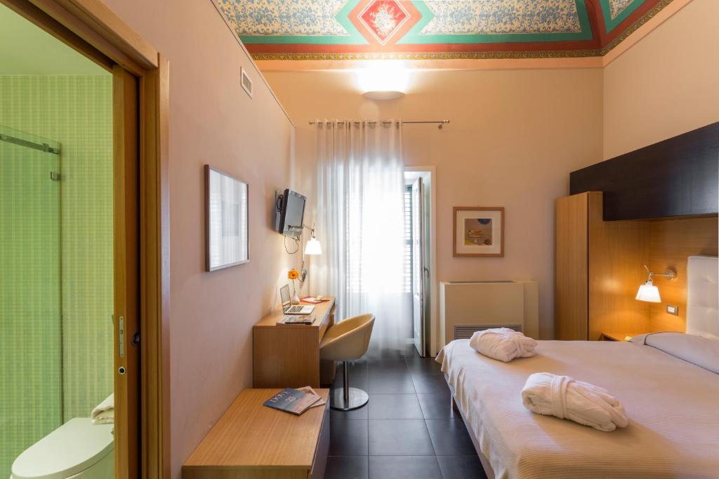Postel nebo postele na pokoji v ubytování Hotel Novecento