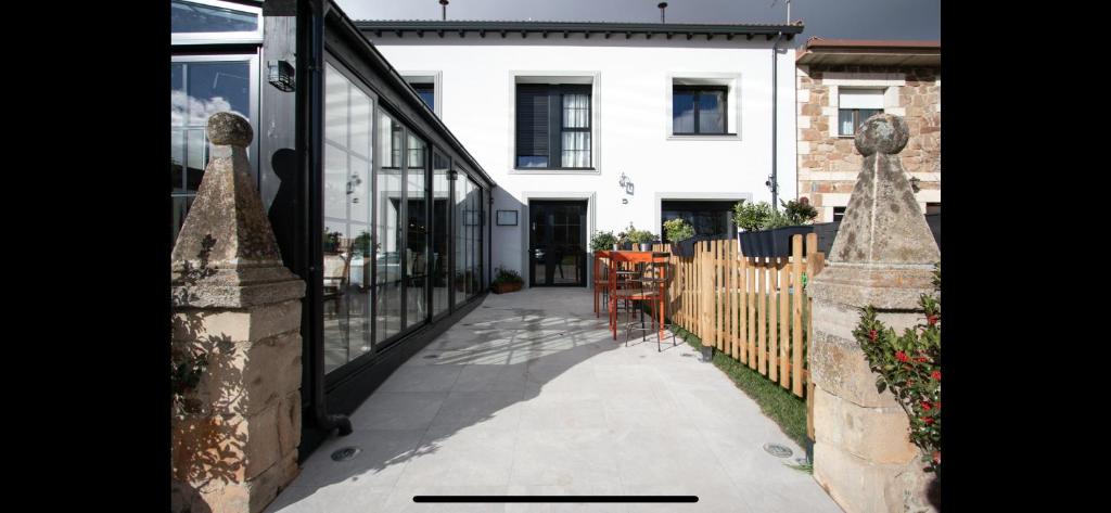 a balcony of a house with a table and a fence at Hotel Apartamento Los Villares in Los Villares de Soria
