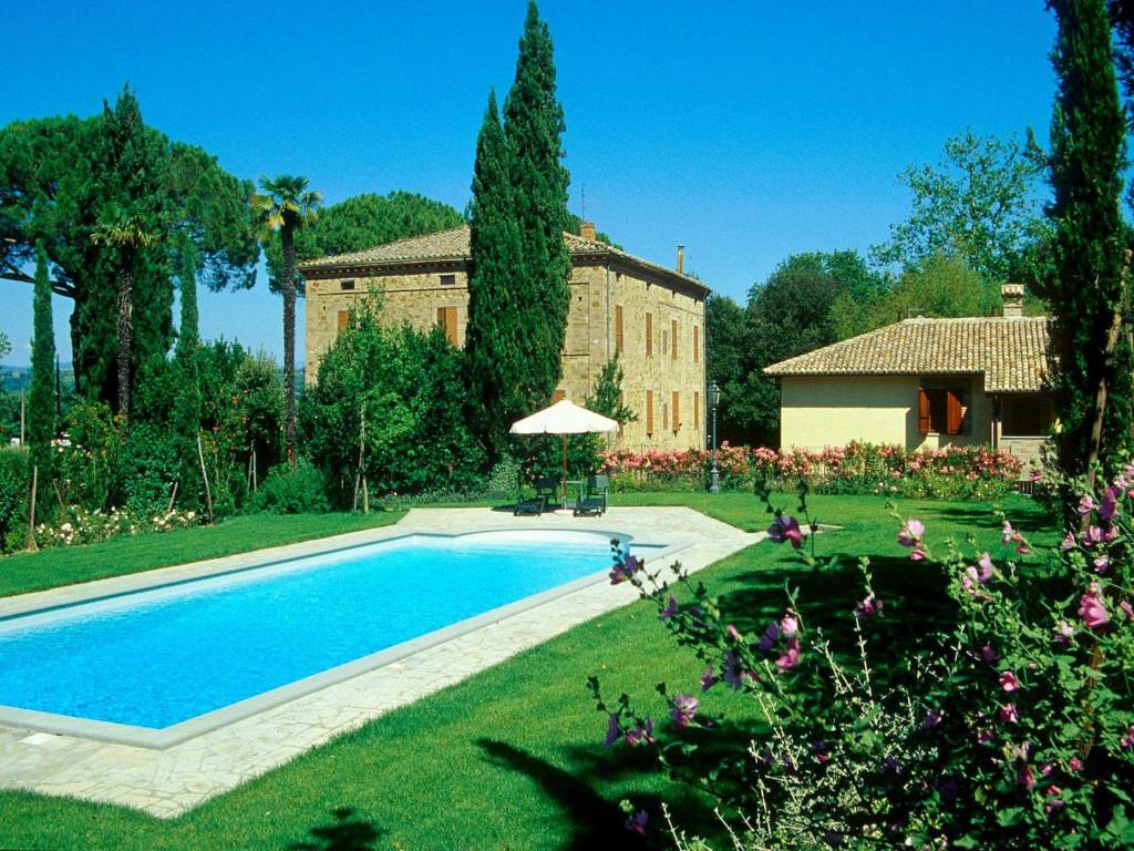 a house with a swimming pool in front of a yard at Apartment in Perugia with Pool & Terrace in Perugia