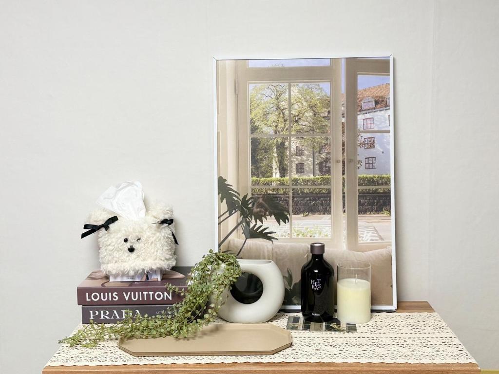 a table with a mirror and a stuffed animal on it at DMC Station,Airport Railroad,Hongdae 10 minutes,King size bed,Family, Group accommodation,JINJIN STAY,Air conditioning in each room in Seoul