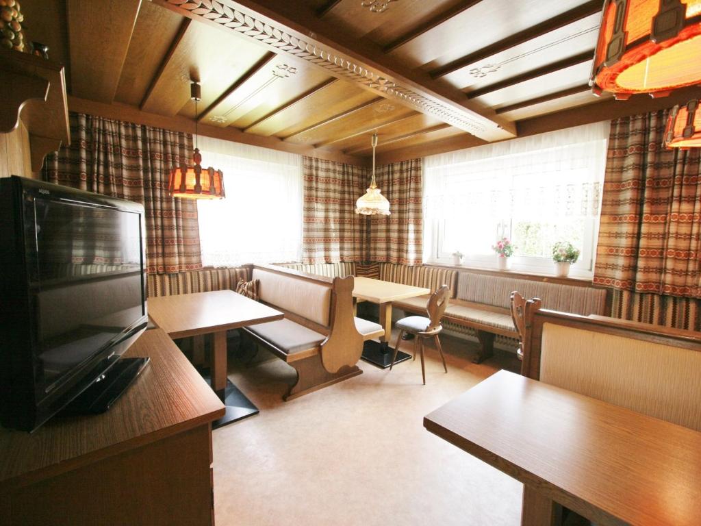 a restaurant with tables and chairs and a television at Chalet in Ellmau near Skiwelt Slopes in Ellmau