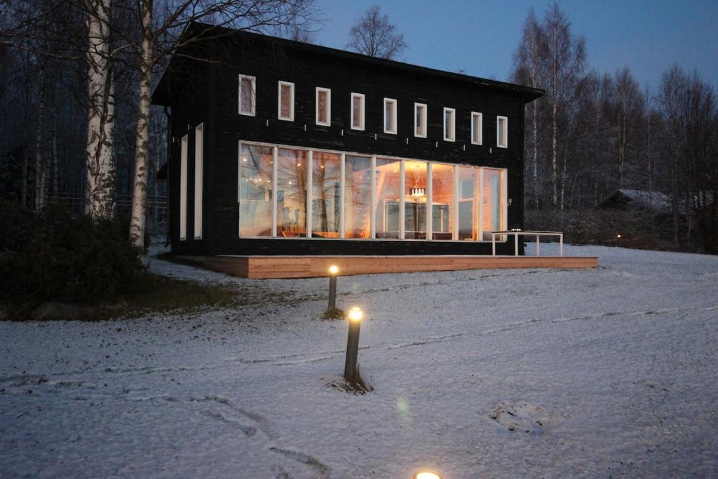 a house in the snow with lights on it at Vietos Villa 