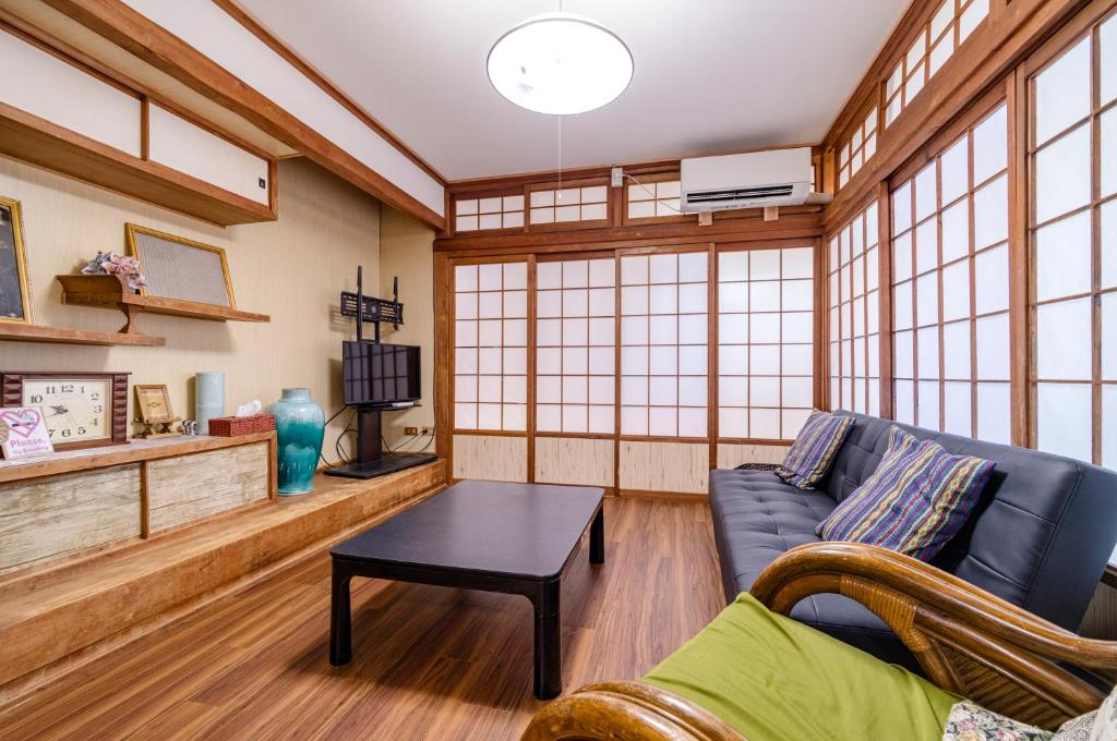 a living room with a blue couch and a table at サフラン in Kumejima