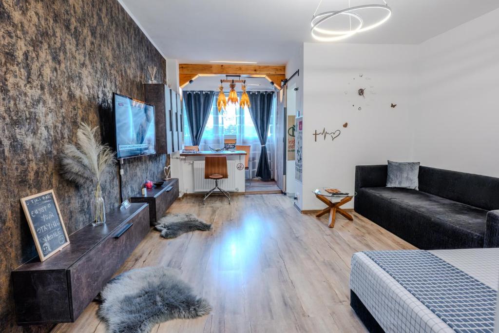 a living room with a couch and a television at Tiki's Bar studio in Bucharest