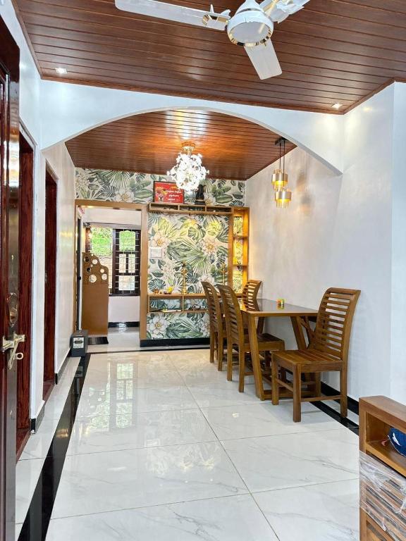 a dining room with a table and chairs at The soul view homestay in Suryanelli