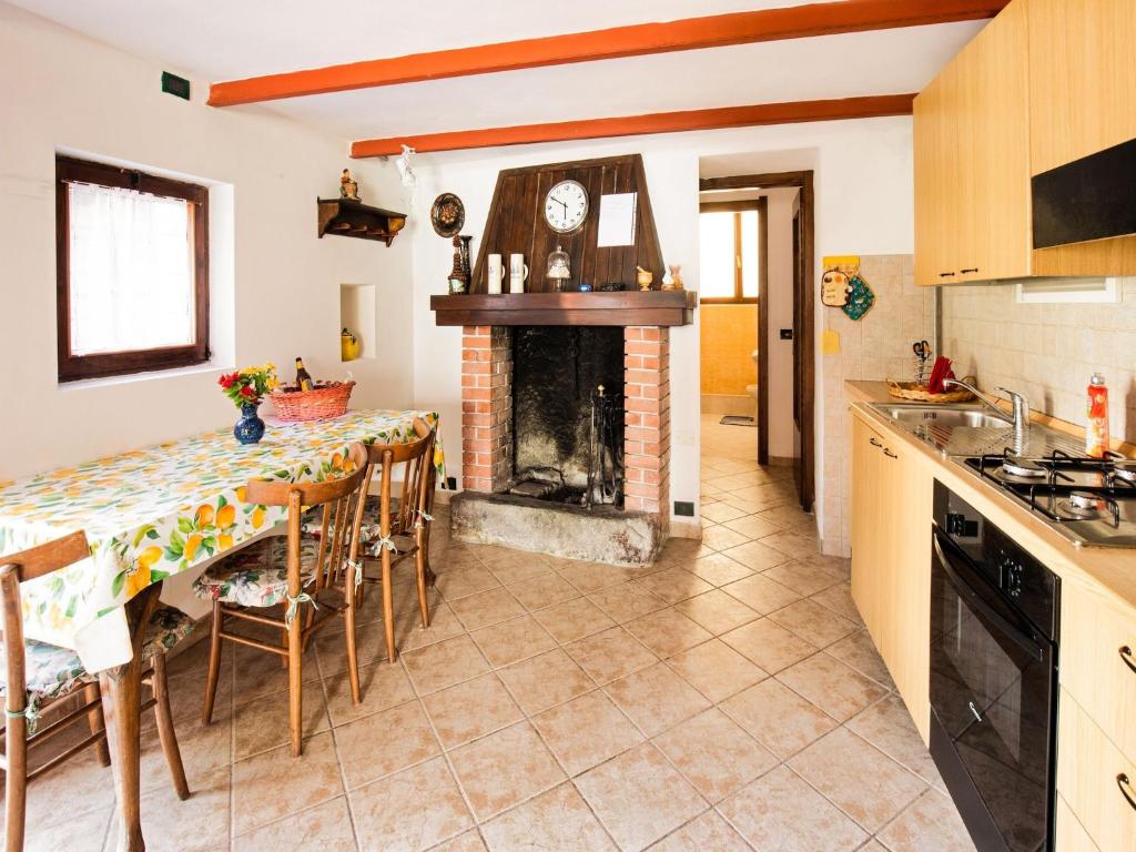 a kitchen with a fireplace and a table with chairs at Lakeside Living with Adventure in Crone