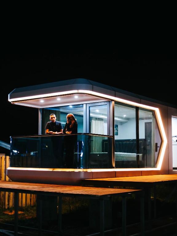 two people standing on the deck of a boat at night at АТЫРАУ Авенью in Zhezdi