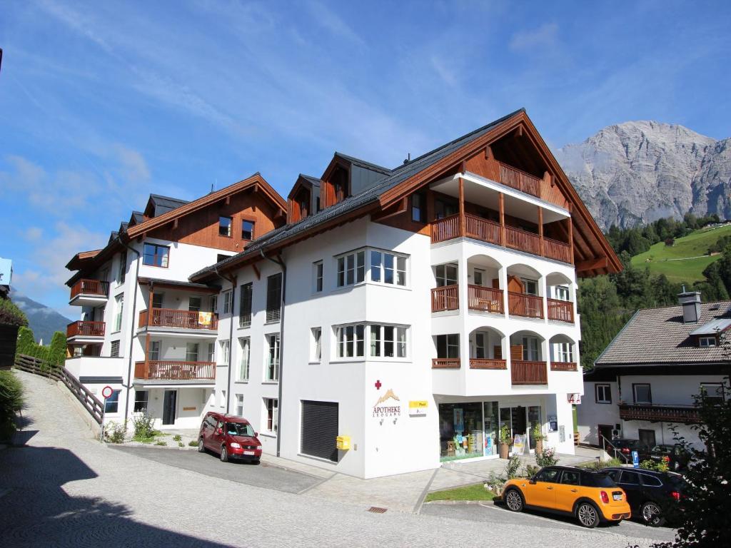 a white apartment building with a brown roof at Apartment in Leogang near Ski Slopes in Leogang
