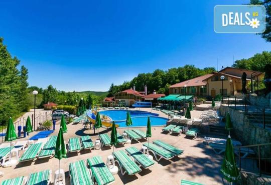 a resort with a swimming pool and lounge chairs at Спа Комплекс Ливадите in Deredzhik-Kʼoy