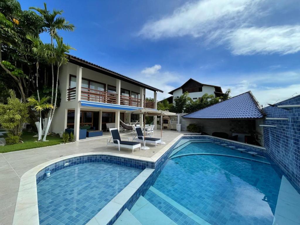 a swimming pool in front of a house at Casa de Luxo in Paulista