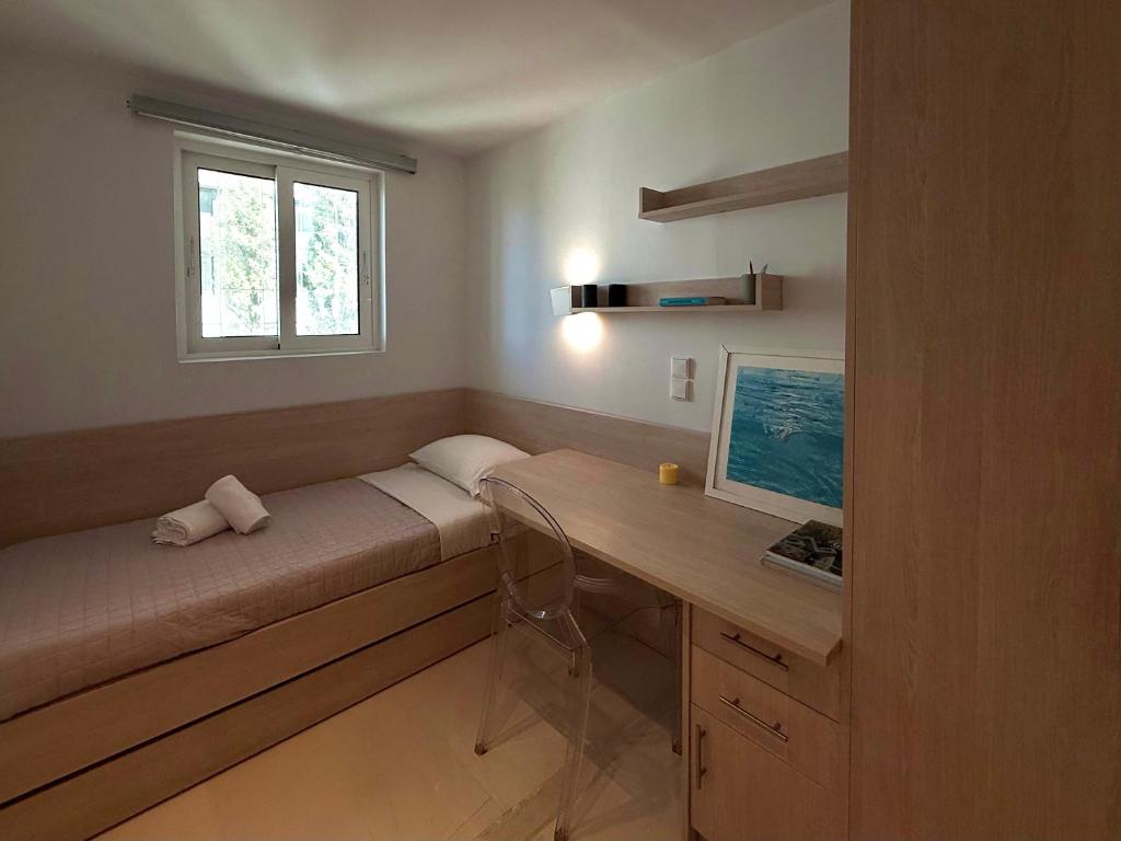 Dream View Vouliagmeni في أثينا: غرفة صغيرة مع مكتب ونافذة