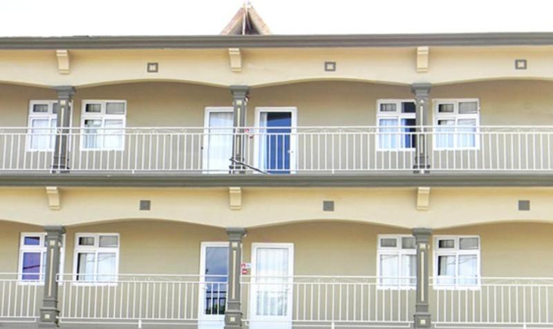 a building with white balconies on the side of it at Villa OSoleil in Grand Baie