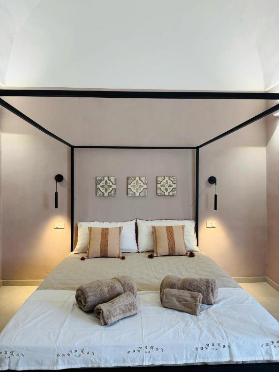 a large bed with two pillows on top of it at Relais Filomarino casa vacanze in Corsano