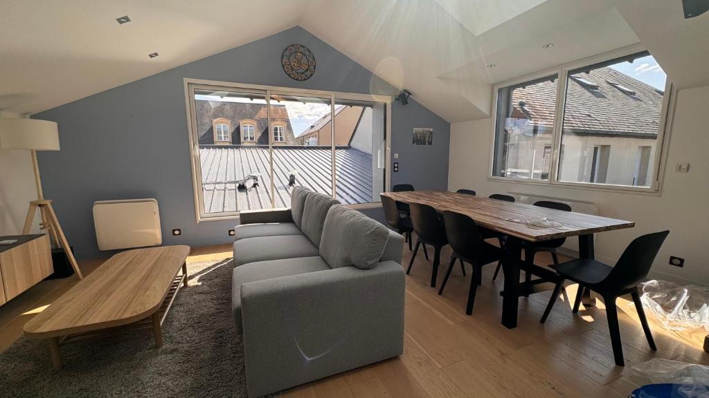 a living room with a couch and a table at LEPTILOFT BAYEUX Centre in Bayeux