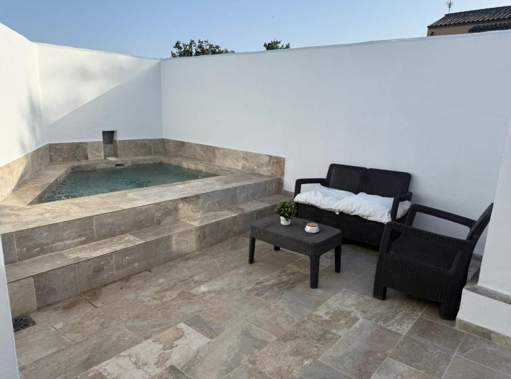 a jacuzzi tub in a room with a couch and a table at Casitas mis niñas in Barbate