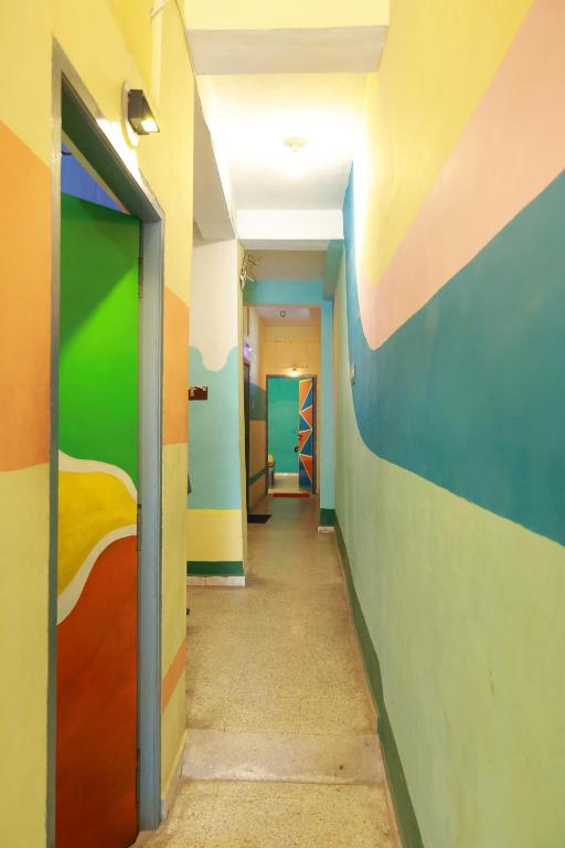 a hallway of a room with colorful walls at Sai Rooms in Puducherry