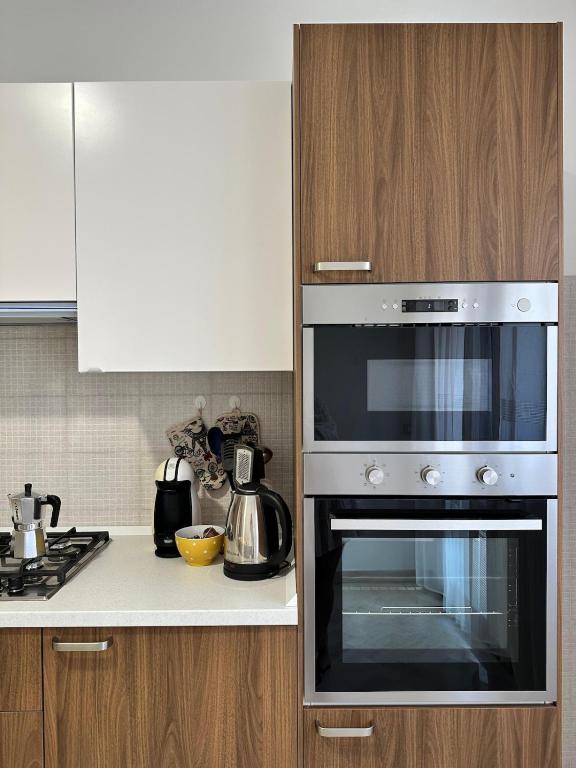 a kitchen with a stove and a microwave at Alba Rosa in Chioggia